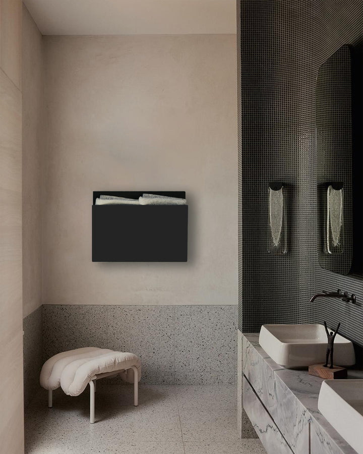 MG12 Geometrici Magazine towel warmer in black in a tiled bathroom