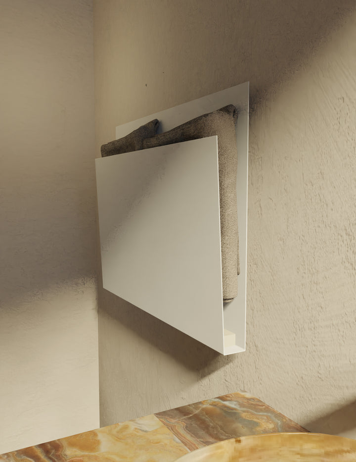 MG12 Geometrici Magazine towel warmer in white with folded towels - angled view