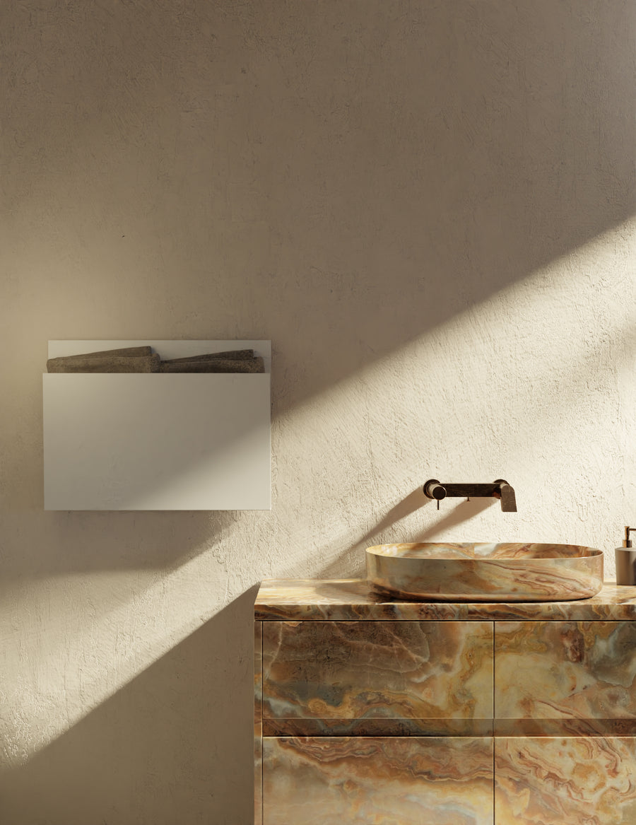 MG12 Geometrici Magazine towel warmer in white above a stone vanity in sunlight