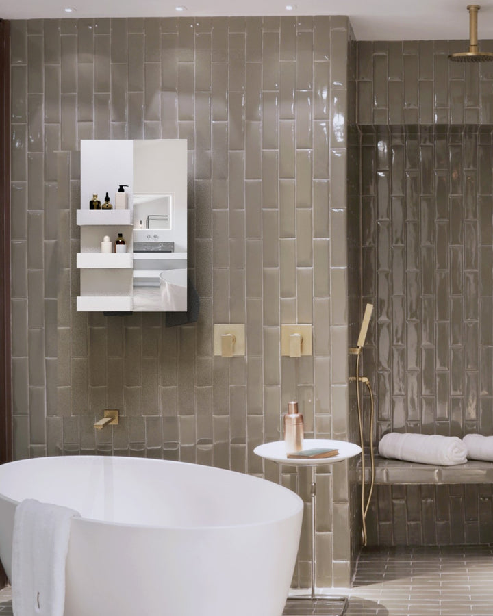 MG12 Geometrici Rectangle and Shelf towel warmer with mirror in a tiled bathroom with a freestanding tub