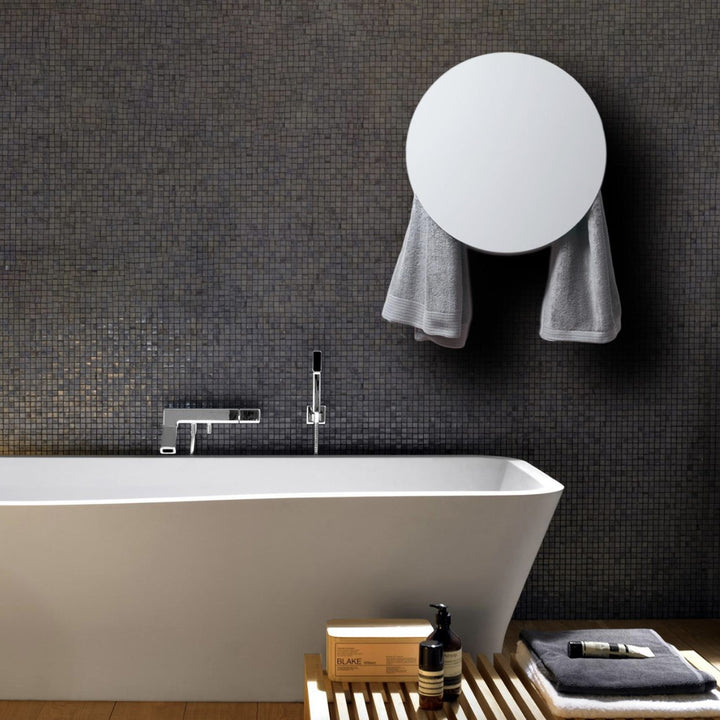 MG12 Geometrici Round towel warmer in white in a dark mosaic tile bathroom with a freestanding tub