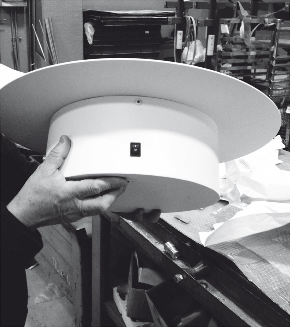 MG12 Geometrici Round towel warmer during production showing the rear housing and control