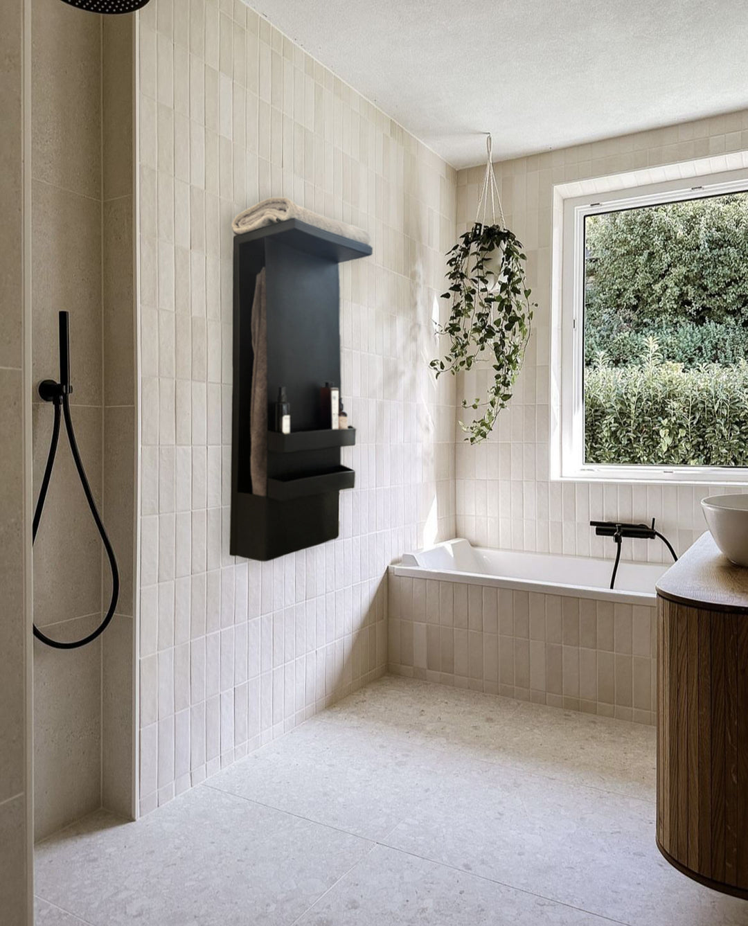 MG12 Geometrici Shelf towel warmer in black mounted in a bright modern bathroom