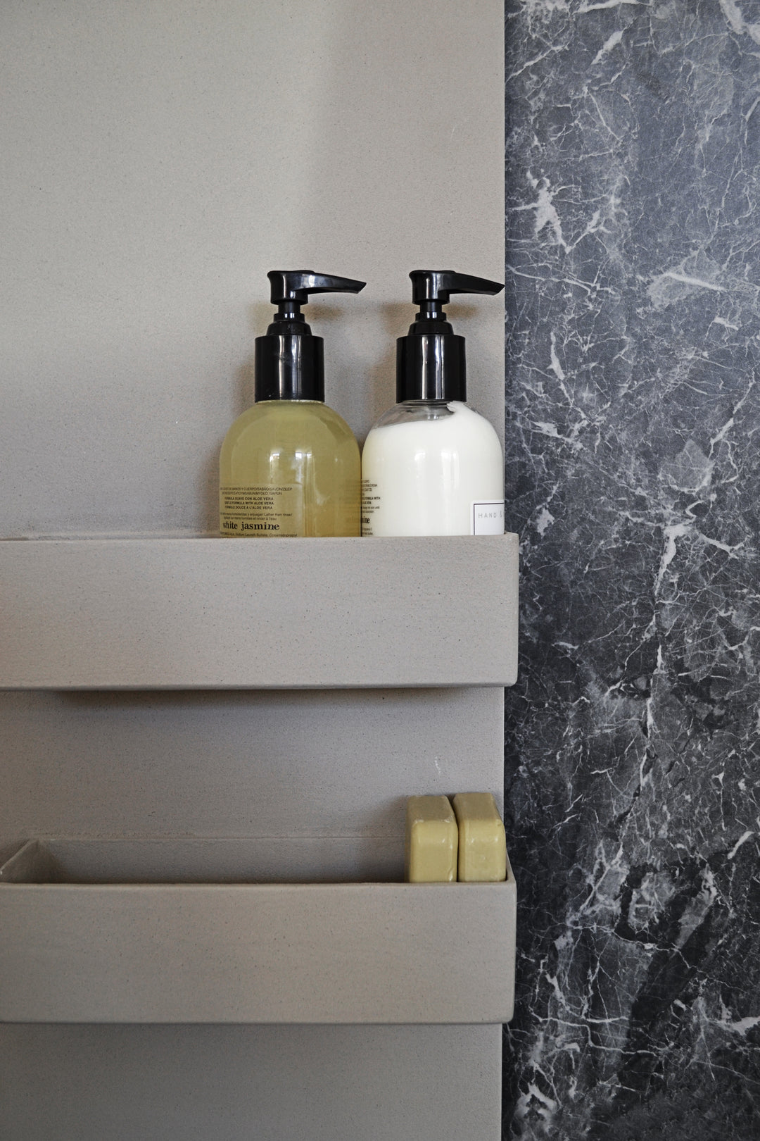 MG12 Geometrici Slim and Shelf towel warmer - close-up of the heated shelves with pump bottles